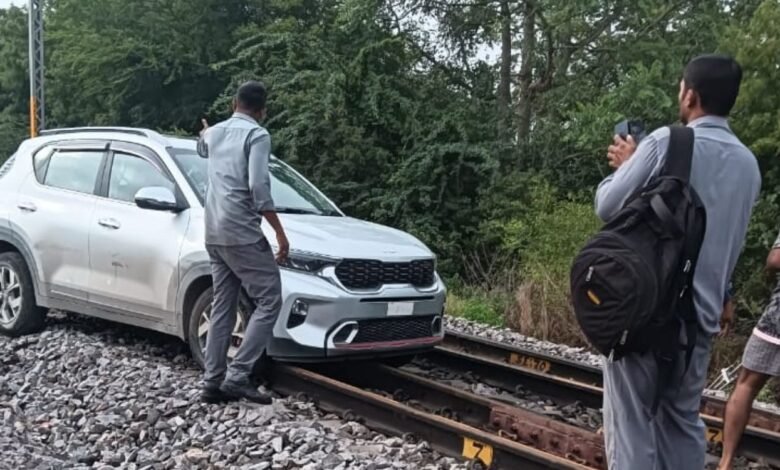 Woman drives car on railway track